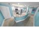 Modern kitchen features white cabinets, stainless steel appliances, and an eat-in island with granite countertops at 3311 S Atlantic Ave # 801, Daytona Beach, FL 32118