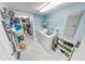 Efficient laundry room features modern washer and dryer, storage shelves, and neutral tile flooring at 3311 S Atlantic Ave # 801, Daytona Beach, FL 32118