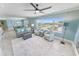 Spacious living area with modern coastal decor, plush seating, and a view of the town at 3311 S Atlantic Ave # 801, Daytona Beach, FL 32118