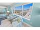 Bright living room featuring comfortable seating and a large window with town views at 3311 S Atlantic Ave # 801, Daytona Beach, FL 32118