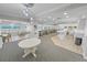 Bright lounge area featuring tables, chairs, and ocean views from many windows at 3311 S Atlantic Ave # 801, Daytona Beach, FL 32118