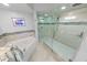 This serene bathroom with walk-in shower and large soaking tub offers relaxation and convenience at 3311 S Atlantic Ave # 801, Daytona Beach, FL 32118