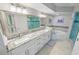 Lavish main bathroom with double sinks, a jetted tub, and a walk-in shower at 3311 S Atlantic Ave # 801, Daytona Beach, FL 32118