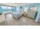 Bright main bedroom featuring a large bed, desk area, and access to a private balcony overlooking the ocean at 3311 S Atlantic Ave # 801, Daytona Beach, FL 32118