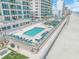 Beautiful aerial view of complex pools, beach access, lounge chairs, and beachfront condos at 3311 S Atlantic Ave # 801, Daytona Beach, FL 32118