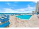 Enjoy the complex pool and lounge area with chairs and ocean views steps from the beach at 3311 S Atlantic Ave # 801, Daytona Beach, FL 32118