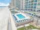 Stunning aerial view of the complex pool area with inviting lounge chairs and direct beach access at 3311 S Atlantic Ave # 801, Daytona Beach, FL 32118