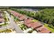 A high-angle aerial shows a community of homes with lush landscaping and backyard screen-enclosed pools at 3376 Leonardo Ln, New Smyrna Beach, FL 32168