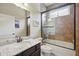 Bathroom featuring tiled walls, large glass enclosed shower over tub, single sink, and granite countertop at 3376 Leonardo Ln, New Smyrna Beach, FL 32168