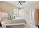 Bedroom featuring plantation shutters, tile flooring, blue bedding, and a ceiling fan at 3376 Leonardo Ln, New Smyrna Beach, FL 32168