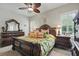 Main bedroom suite with large bed, dresser, nightstands, and ceiling fan at 3376 Leonardo Ln, New Smyrna Beach, FL 32168