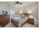 Bedroom features wood furniture, tile flooring, tropical bedding, and plantation shutters at 3376 Leonardo Ln, New Smyrna Beach, FL 32168