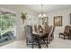 Formal dining room featuring elegant wood table, decorative chairs, and pool view at 3376 Leonardo Ln, New Smyrna Beach, FL 32168