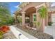 Covered porch featuring mature tropical landscaping and an inviting walkway to the front door at 3376 Leonardo Ln, New Smyrna Beach, FL 32168