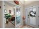 Welcoming foyer features decorative glass doors, tiled flooring, and natural light at 3376 Leonardo Ln, New Smyrna Beach, FL 32168