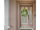 A charming front door featuring decorative glass and a wreath to enhance the curb appeal at 3376 Leonardo Ln, New Smyrna Beach, FL 32168