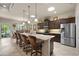 Spacious kitchen features a large island with seating, stainless steel appliances, and dark wood cabinets at 3376 Leonardo Ln, New Smyrna Beach, FL 32168