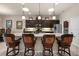 Modern kitchen featuring a large island with bar stools, dark wood cabinetry and stainless steel appliances at 3376 Leonardo Ln, New Smyrna Beach, FL 32168