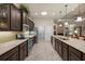 Modern kitchen with an extended island, stainless steel appliances, dark wood cabinets, and a tile floor at 3376 Leonardo Ln, New Smyrna Beach, FL 32168