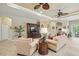 Bright living room boasts tile floors, ceiling fans, and a cozy seating arrangement at 3376 Leonardo Ln, New Smyrna Beach, FL 32168