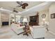Spacious living room featuring tile floors, fireplace, ceiling fans, and comfortable seating at 3376 Leonardo Ln, New Smyrna Beach, FL 32168