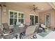 Inviting covered patio features a ceiling fan, stylish furniture, and an outdoor dining area for relaxation at 3376 Leonardo Ln, New Smyrna Beach, FL 32168