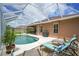 Backyard featuring pool, patio, barbecue area, and a beautifully landscaped surrounding, perfect for entertaining at 3376 Leonardo Ln, New Smyrna Beach, FL 32168
