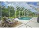 Lush backyard is a screen enclosed pool area with mature landscaping and a tranquil retreat at 3376 Leonardo Ln, New Smyrna Beach, FL 32168