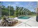 Lush backyard is a screen enclosed pool area with mature landscaping and a tranquil retreat at 3376 Leonardo Ln, New Smyrna Beach, FL 32168