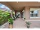 An inviting covered porch with comfortable seating and lush landscaping at 3376 Leonardo Ln, New Smyrna Beach, FL 32168