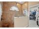Walk-in shower with glass surround, mosaic tile, window, and access to a walk-in closet at 3376 Leonardo Ln, New Smyrna Beach, FL 32168