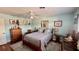 Bright bedroom with a ceiling fan, hard floors, and natural light from the windows at 34 Richmond Dr, New Smyrna Beach, FL 32169
