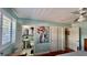 Bedroom view showing the en suite bathroom, wood floors, and ceiling fan at 34 Richmond Dr, New Smyrna Beach, FL 32169