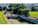 Featuring a concrete boat ramp with lush landscaping and a partial view of a house at 34 Richmond Dr, New Smyrna Beach, FL 32169