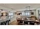 Bright dining area featuring a long wood table set, plantation shutters, and decor art at 34 Richmond Dr, New Smyrna Beach, FL 32169