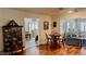 Cozy dining area features a round wood table set, hardwood floors, and an elegant china cabinet at 34 Richmond Dr, New Smyrna Beach, FL 32169