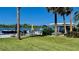 Beautiful waterfront view of boat dock with table, chairs, canopy, and boat at 34 Richmond Dr, New Smyrna Beach, FL 32169