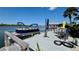 Waterfront boat dock featuring a boat, table, chairs, and canopy at 34 Richmond Dr, New Smyrna Beach, FL 32169