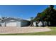 Exterior of home featuring a paver driveway and well manicured lawn at 34 Richmond Dr, New Smyrna Beach, FL 32169