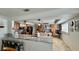 Bright open concept kitchen with granite countertops, custom cabinets, and breakfast bar seating at 34 Richmond Dr, New Smyrna Beach, FL 32169
