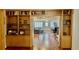 Open-concept living room and dining area with built in bookshelves and hardwood floors at 34 Richmond Dr, New Smyrna Beach, FL 32169
