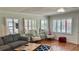 Bright living room featuring plantation shutters, hardwood floors and elegant furnishings at 34 Richmond Dr, New Smyrna Beach, FL 32169