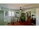 Office with green cabinetry, a desk, and an elegant hardwood floor, creating a stylish workspace at 34 Richmond Dr, New Smyrna Beach, FL 32169