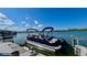 Pontoon boat docked in the water, offering leisurely cruises and enjoying the surrounding waterfront scenery at 34 Richmond Dr, New Smyrna Beach, FL 32169