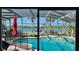 Sparkling pool area surrounded by palm trees with stunning waterfront views at 34 Richmond Dr, New Smyrna Beach, FL 32169