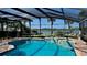The enclosed pool boasts tile accents and scenic views of the water, creating an inviting oasis at 34 Richmond Dr, New Smyrna Beach, FL 32169