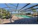 Relaxing screened-in pool area with comfortable seating and a stunning waterfront view at 34 Richmond Dr, New Smyrna Beach, FL 32169