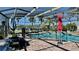 A fenced pool offers safety, while patio furniture and umbrellas create an ideal relaxation and entertainment space at 34 Richmond Dr, New Smyrna Beach, FL 32169