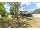 A serene fenced backyard featuring a pool, a grill, and a well-manicured lawn on a sunny day at 35 Knollwood Estates Dr, Ormond Beach, FL 32174