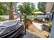 Backyard with a pool, outdoor seating, and landscaping with palm trees and other plants at 35 Knollwood Estates Dr, Ormond Beach, FL 32174